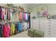 Spacious walk-in closet with ample storage, custom shelving, and stylish ottomans at 1351 N Classic Ct, Longwood, FL 32779