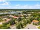 Expansive aerial view showcases the surrounding community, lake, and lush greenery at 1517 Edenhall Pt, Lake Mary, FL 32746