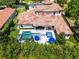Aerial view of a luxurious home with a private pool, spa, and a meticulously manicured backyard at 1517 Edenhall Pt, Lake Mary, FL 32746