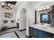 Luxurious bathroom featuring a modern sink, unique light fixture, with arched doorways at 1517 Edenhall Pt, Lake Mary, FL 32746