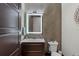 Modern bathroom featuring stylish fixtures, a dark wood vanity, and herringbone accent wall at 1517 Edenhall Pt, Lake Mary, FL 32746