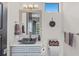 Stylish powder room with a unique vessel sink, marble countertop, and modern fixtures at 1517 Edenhall Pt, Lake Mary, FL 32746
