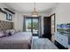 Bedroom features a tray ceiling, modern lighting and balcony access at 1517 Edenhall Pt, Lake Mary, FL 32746