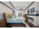 Stately bedroom with tray ceilings, fireplace, hardwood floors, and a decorative chandelier at 1517 Edenhall Pt, Lake Mary, FL 32746