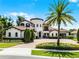 Stunning Mediterranean-style home with lush landscaping, circular driveway, and a grand palm tree at 1517 Edenhall Pt, Lake Mary, FL 32746