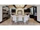 Gourmet kitchen with dark wood cabinetry, a large island with seating, and stainless steel appliances at 1517 Edenhall Pt, Lake Mary, FL 32746