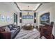 Living room with decorative windows, custom lighting, leather sofa and rug at 1517 Edenhall Pt, Lake Mary, FL 32746