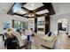 Cozy living room with a fireplace, modern ceiling design, and access to the outdoor living space at 1517 Edenhall Pt, Lake Mary, FL 32746