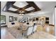 Expansive living room with beamed ceiling, tile floors, and an open floor plan with modern furnishings at 1517 Edenhall Pt, Lake Mary, FL 32746
