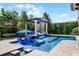 Inviting pool with waterfall, lounge chairs and lush landscaping in backyard setting at 1517 Edenhall Pt, Lake Mary, FL 32746
