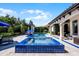 Inviting pool with spa, waterfall feature, and travertine tile deck at 1517 Edenhall Pt, Lake Mary, FL 32746