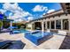 Backyard pool and spa featuring travertine tile deck and lush landscaping at 1517 Edenhall Pt, Lake Mary, FL 32746