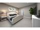 Serene bedroom with soft lighting, neutral colors, and ample space for relaxation at 1856 Archer Dr, Minneola, FL 34715