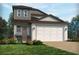 Charming two-story home featuring a two-car garage, stone accents, and a well-manicured lawn at 1856 Archer Dr, Minneola, FL 34715