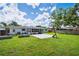Large backyard featuring a lush green lawn, patio space, and a basketball hoop at 2102 Ivanhoe Rd, Orlando, FL 32804