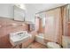 Pink tiled bathroom with unique vintage fixtures, creating a charming and nostalgic ambiance at 2102 Ivanhoe Rd, Orlando, FL 32804