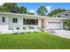 The attractive home features a well maintained front lawn with decorative chairs and front entry at 2102 Ivanhoe Rd, Orlando, FL 32804