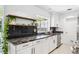 Modern kitchen with granite countertops, stainless steel appliances, white cabinets, and stylish black backsplash at 2102 Ivanhoe Rd, Orlando, FL 32804