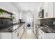 Updated kitchen features granite countertops, custom cabinets, and stainless steel appliances at 2102 Ivanhoe Rd, Orlando, FL 32804