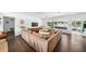 Bright living room with hardwood floors, large sofa, and expansive view of the dining room at 2102 Ivanhoe Rd, Orlando, FL 32804