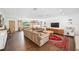 Large living room featuring a sectional sofa, flat screen TV, and well-lit open floor plan at 2102 Ivanhoe Rd, Orlando, FL 32804