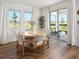 Bright dining area with a round table, large windows, and sliding door access to the outdoors at 2272 Hen Rd, Minneola, FL 34715