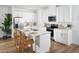 Modern kitchen features white cabinets, stainless steel appliances, and a center island with bar seating at 2272 Hen Rd, Minneola, FL 34715