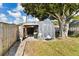 A spacious backyard shed sits on a grassy lawn, offering convenient storage with an open extension on the side at 2356 Date Palm Dr, Edgewater, FL 32141