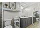 Modern bathroom with double sink vanity, stylish lighting, and a convenient toilet, exuding elegance at 2356 Date Palm Dr, Edgewater, FL 32141