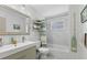 Stylish bathroom features a sleek vanity, tiled walls, and modern fixtures, providing a clean and updated look at 2356 Date Palm Dr, Edgewater, FL 32141