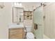 Modern bathroom with a vanity sink, toilet, tiled shower with glass door, and decorative shelving at 2356 Date Palm Dr, Edgewater, FL 32141