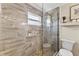 Elegant bathroom featuring a glass shower with multiple sprayers and pebble flooring detail at 2356 Date Palm Dr, Edgewater, FL 32141
