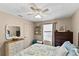 Serene bedroom with ceiling fan, neutral walls, and ample natural light creates a relaxing and inviting space at 2356 Date Palm Dr, Edgewater, FL 32141