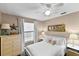 Inviting bedroom with a ceiling fan, window with blinds, dresser, and two bedside tables at 2356 Date Palm Dr, Edgewater, FL 32141