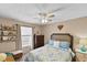 Comfortable bedroom with ceiling fan, large window, and neutral décor at 2356 Date Palm Dr, Edgewater, FL 32141