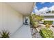 Inviting front entrance with a well-lit walkway, complemented by lush landscaping and decorative touches at 2356 Date Palm Dr, Edgewater, FL 32141