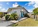 Charming home exterior with bright blue door, manicured landscaping and gray siding at 2356 Date Palm Dr, Edgewater, FL 32141