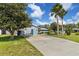 Lovely home with a well-kept lawn and a long driveway leading to a turquoise door at 2356 Date Palm Dr, Edgewater, FL 32141