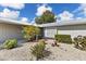 Well-maintained front yard features decorative rock landscaping, mature plantings and accent fencing at 2356 Date Palm Dr, Edgewater, FL 32141