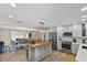 Open kitchen design with a central island, stainless steel appliances, and views into the dining area at 2356 Date Palm Dr, Edgewater, FL 32141