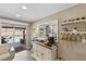 Cozy kitchenette near sliding glass doors showcases custom cabinets, a wine rack, and access to outdoor pool area at 2356 Date Palm Dr, Edgewater, FL 32141
