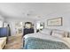 Spacious main bedroom showcases a decorative rug, an ensuite bathroom, and ample natural light at 2356 Date Palm Dr, Edgewater, FL 32141