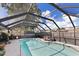 Sparkling screened-in pool with lounge chairs, surrounded by patio space and lush landscaping at 2356 Date Palm Dr, Edgewater, FL 32141