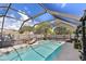 Inviting screened-in pool area perfect for relaxation and entertaining with lounge chair, decor, and sunny skies above at 2356 Date Palm Dr, Edgewater, FL 32141