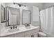 Bright bathroom featuring double vanity with quartz countertop and modern black fixtures at 2451 Ridgemoor Dr, Orlando, FL 32828