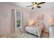 Cozy bedroom with pink decor, a plush bed, and soft natural light creating a serene atmosphere at 2451 Ridgemoor Dr, Orlando, FL 32828