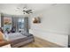 Bright bedroom with water view, television, and wood-look flooring at 2451 Ridgemoor Dr, Orlando, FL 32828