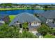 Stunning lakefront home showcasing lush landscaping and architectural details against a serene water backdrop at 2451 Ridgemoor Dr, Orlando, FL 32828