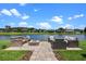 Outdoor patio with comfortable seating area and tranquil lake views in the background at 2451 Ridgemoor Dr, Orlando, FL 32828