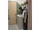 Functional laundry room equipped with a washing machine and built in storage and lots of shelving at 2932 Silver Ridge Dr, Orlando, FL 32818